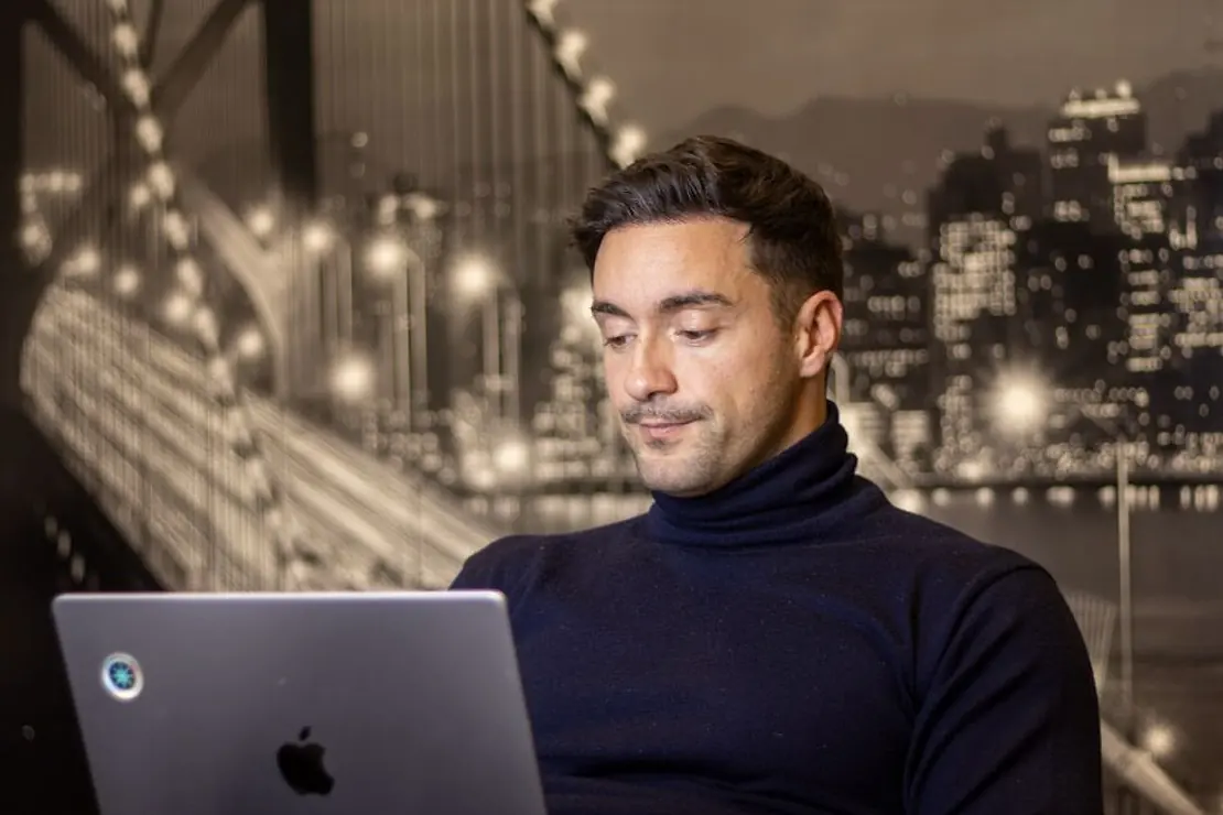Influencer marketing platform operator working on a laptop