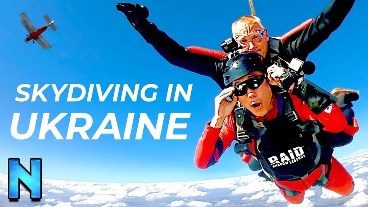 Tandem skydivers free-fall above clouds, front one in a "RAID SHADOW LEGENDS" harness; text "SKYDIVING IN UKRAINE"