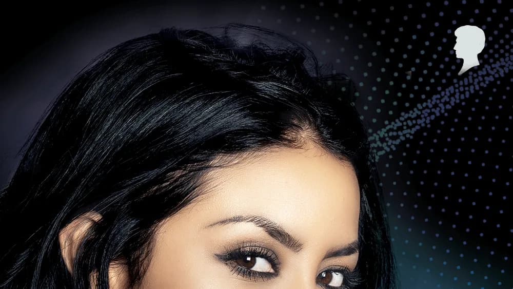 Woman with glossy black hair and dark eye makeup gazes at camera beside a Schwarzkopf Professional silhouette logo