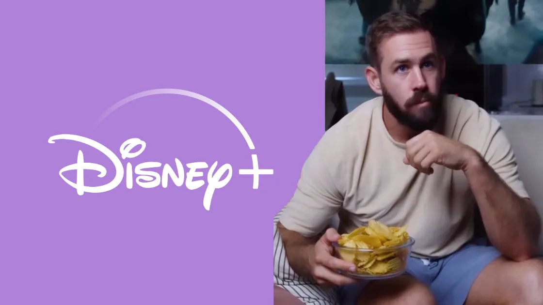 Disney+ logo on purple beside a bearded man on a couch holding a bowl of chips, eating while watching a screen