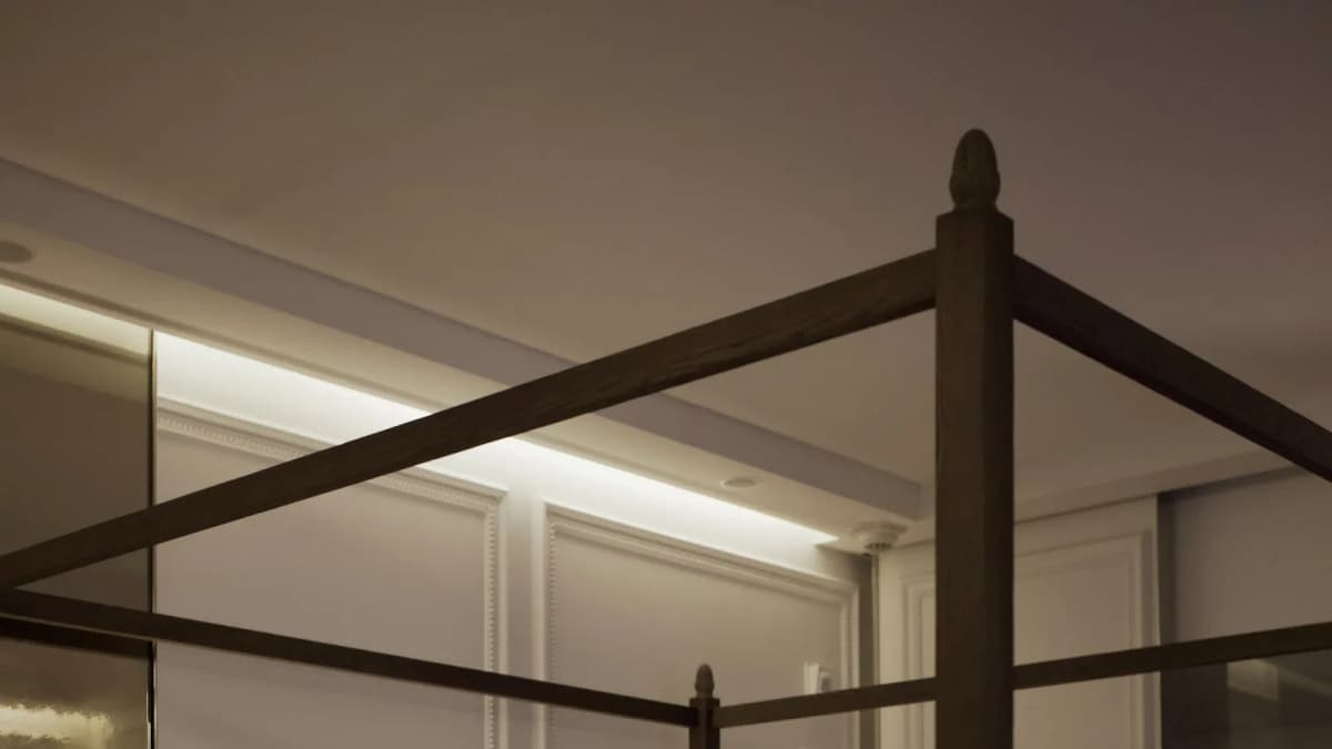 Baccarat Hotels, four-poster bed with white linen in a softly lit hotel bedroom