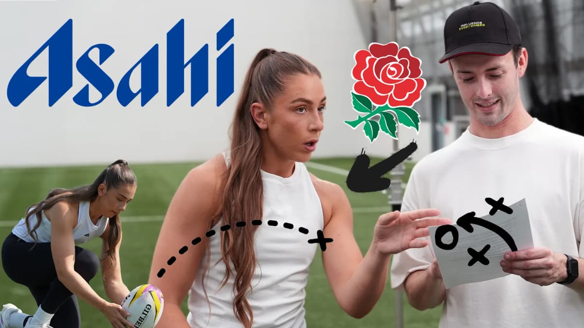 "Asahi" logo, a woman gesturing to a man in a cap reading a sheet, and a kneeling woman holding a rugby ball on turf