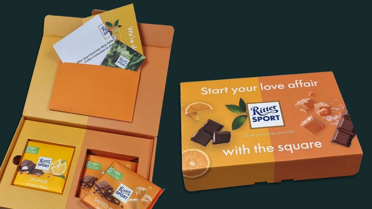 Open Ritter Sport box with chocolate bars and cards beside a closed box reading "Start your love affair with the square"
