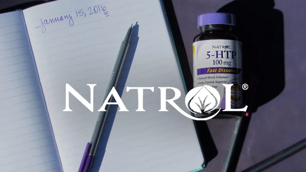 Natrol "5-HTP 100 mg" bottle beside open notebook dated "January 15, 2016" and pens, Natrol logo overlaid